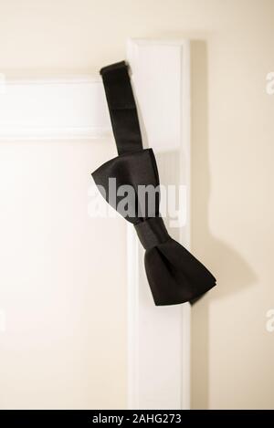 black bow tie in bed Stock Photo