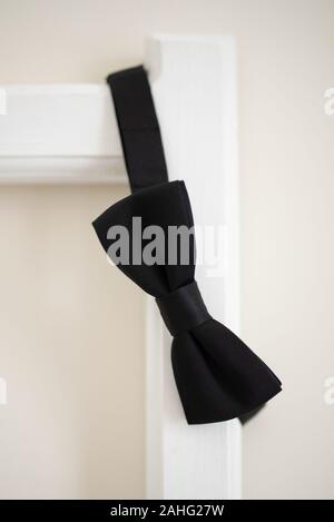 black bow tie in bed Stock Photo