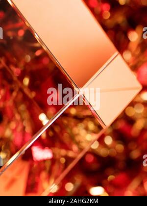 Christmas theme red and golden blurred defocused background with sparkles and glitters. Stock Photo