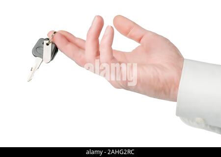 Man hand giving or offering keys to someone. Isolated on white, clipping path included Stock Photo