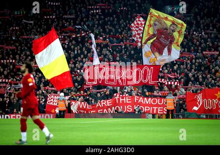 Liverpool fans in the stands hold up banners and flags to show their support during the Premier League match at Anfield Stadium, Liverpool. Stock Photo