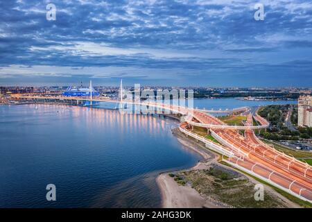 Illuminated high speed highway in Saint Petersburg, Russia with cable stayed bridge. Night aerial view Stock Photo