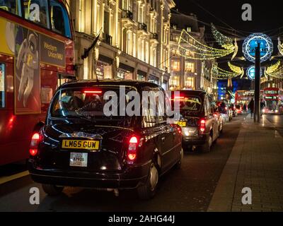 Taxi's waiting in traffic during the festive period on Regent Street, London. Stock Photo