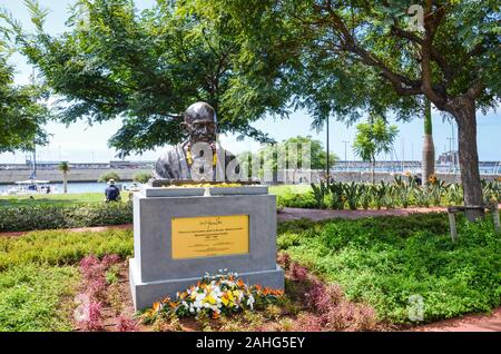 Funchal, Madeira, Portugal - Sep 10 2019: Memorial of Mahatma Gandhi, famous Indian anti-colonial nationalist, in the Madeiran capital. Park and harbor in the background. Stock Photo