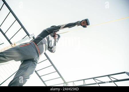 Bottom view of the boxer training with the rubber rope Stock Photo