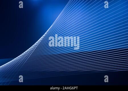 Blue abstract technology, science or business background. Threads and lines of light intersect and create winding geometric forms in perspective Stock Photo