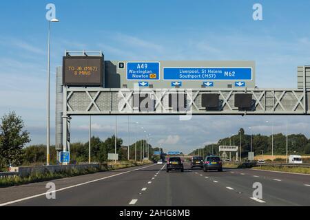 UK motorway, road sign showing directions to A49 Warrington, Newton and M62 Liverpool, St Helens, Southport (M57) Stock Photo