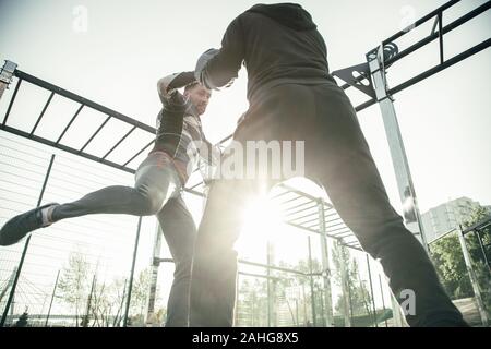 Strong MMA boxer pushing his opponent while training Stock Photo