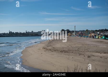 A shot of Santa Cruz beach with the board on the right side and the wharf in the background. Stock Photo