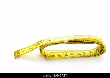 Ruler for sewing in yellow color with black numbers, isolated on white background with copy space. Minimalistic concept of diet and fitness Stock Photo