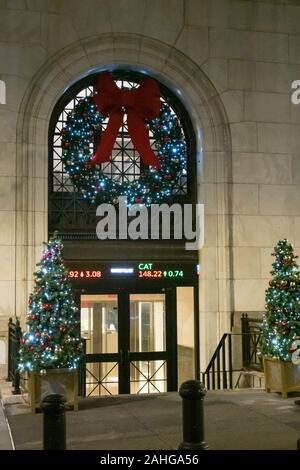 The New York Stock Exchange is festively decorated with lights and garlands during the holiday season, NYC, USA Stock Photo