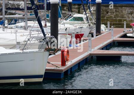 Sailboats and yachts docked on small pier in San Sebastian, Basque Country Stock Photo