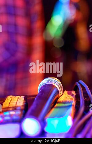 Public performance on stage Microphone on stage against a background of auditorium. Shallow depth of field. Public performance on stage. Stock Photo