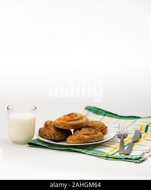 Domestic Home made Rolled pastry with spinach and cheese on a napkin with a glass of Yogurt Stock Photo