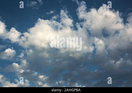 Image of broken white clouds that threaten to cover the sky. Conceptual Stock Photo