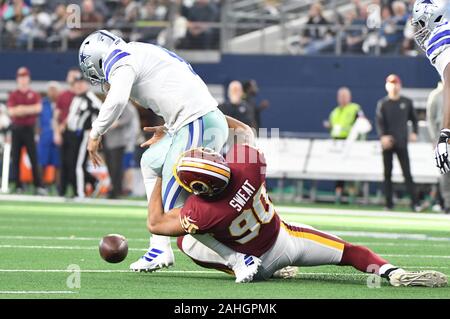 Arlington, United States. 29th Dec, 2019. Dallas Cowboys quarterback Dak Prescott (4) fumbles as he is asked by Washington Redskins linebacker Montez Sweat (90) in the first half of their NFL game at AT&T Stadium in Arlington, Texas on Sunday, December 29, 2019. Photo by Ian Halperin/UPI Credit: UPI/Alamy Live News Stock Photo