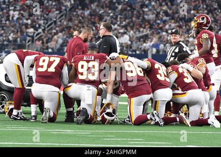 Arlington, United States. 29th Dec, 2019. Washington Redskins players need for a moment of prayer after teammate Maurice Smith was injured in the first quarter against the Dallas Cowboys at AT&T Stadium in Arlington, Texas on Sunday, December 29, 2019. Photo by Ian Halperin/UPI Credit: UPI/Alamy Live News Stock Photo