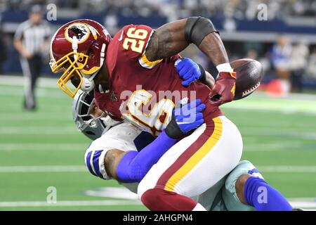 Arlington, United States. 29th Dec, 2019. Washington Redskins running back Adrian Peterson (26) fumbles as he is hit by Dallas Cowboys outside linebacker Malcolm Smith (43) during their NFL game at AT&T Stadium in Arlington, Texas on Sunday, December 29, 2019. Photo by Ian Halperin/UPI Credit: UPI/Alamy Live News Stock Photo