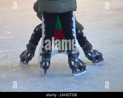 a carefree day at ice skating park, Italian winter under the Alps mountains Stock Photo