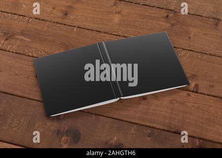 Blank black square open and upside down book cover on wooden boards isolated with clipping path around cover Stock Photo