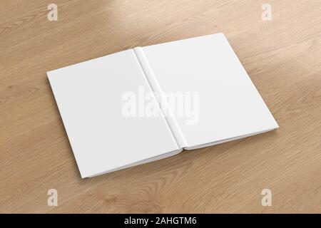 Blank white vertical open and upside down book cover on wooden background isolated with clipping path around cover Stock Photo