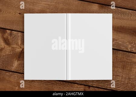 Blank white vertical open and upside down book cover on wooden boards isolated with clipping path around cover Stock Photo