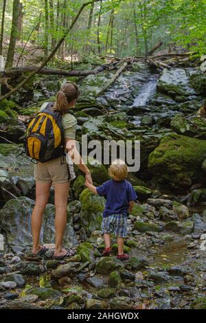 Mother and young son enjoying a day in the woods Stock Photo
