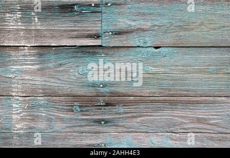 Old wooden wall with peeling green paint layer, background photo texture Stock Photo