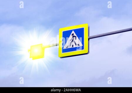 Pedestrian crossing road sign symbol. Bright blue and and luminous yellow pedestrian crosswalk sign Stock Photo