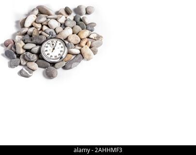 Stopwatch on several stones a white background. Timing. Time in sport. Stock Photo