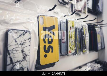 Phuket, Thailand - 10 December 2018 : IOS and android mobile case with many pattern and design, the main one say "YES." on yellow background Stock Photo