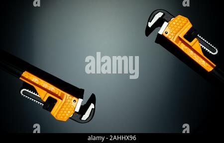 Set of new chrome pipe wrench with yellow handle isolated on dark background. Metal monkey wrench for plumber.  Mechanic tools. Hardware for fix Stock Photo