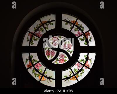 Artwork on glass and wooden window with flowers etched on the glass Stock Photo