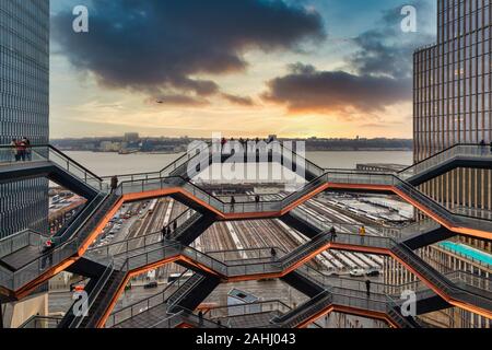 Vessel (hudson yards redevelopment project ) in NYC at sunset with clouds in sky Stock Photo