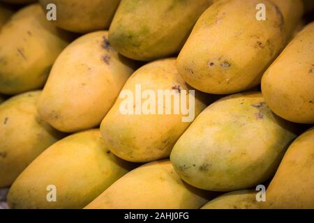 close up Mangoes pile put together have pattern in front of shop at market Stock Photo