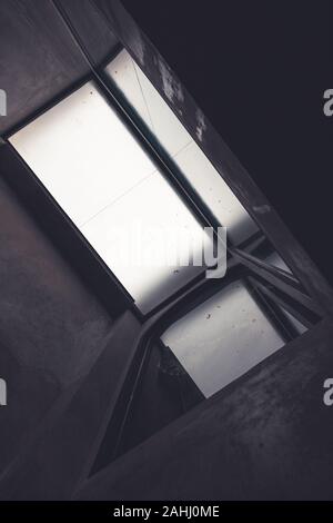 Rooftop reflect on the window to show art of shape in dark tone Stock Photo
