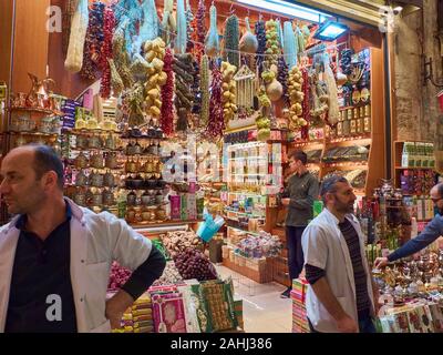 Istanbul, Turkey - December 2019. Merchants stand near market counter at Spice Bazaar. Stock Photo