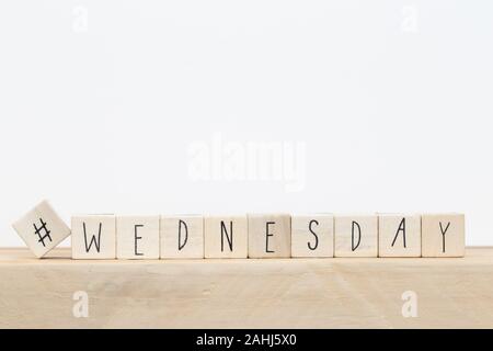 Wooden cubes with a hashtag and the word wednesday, social media concept near white background Stock Photo