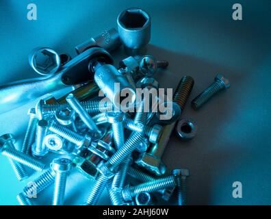 small ratchet with torx nuts in the background and many screws Stock Photo