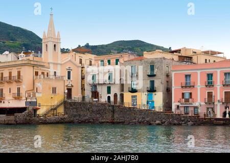 San Giuseppe church and multicolored houses in Lipari port, Aeolian islands, Italy Stock Photo