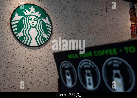 American multinational chain, Starbucks Coffee logo seen at Hong Kong international airport. Stock Photo