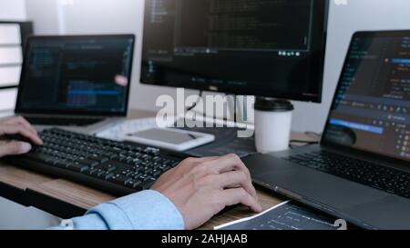 Programmer Typing Code on desktop computer, Developing programming and coding technologies concept Stock Photo