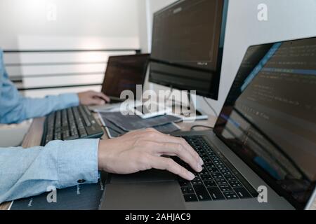 Programmer Typing Code on desktop computer, Developing programming and coding technologies concept Stock Photo