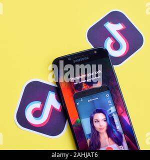 NY, USA - DECEMBER 5, 2019: Tiktok application on samsung smartphone screen on yellow background. TikTok is a popular video-sharing social networking Stock Photo