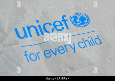 NY, USA - DECEMBER 29, 2019: Unicef blue logo on brown paper bag, United Nations Childrens Fund is agency responsible for providing humanitarian and d Stock Photo