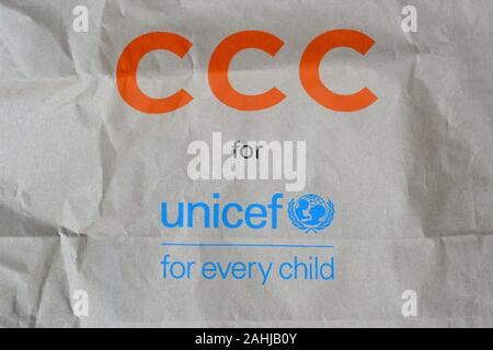 NY, USA - DECEMBER 29, 2019: Unicef blue logo on brown paper bag, United Nations Childrens Fund is agency responsible for providing humanitarian and d Stock Photo