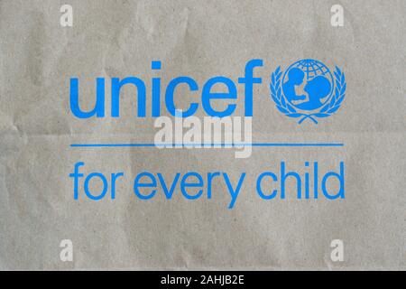 NY, USA - DECEMBER 29, 2019: Unicef blue logo on brown paper bag, United Nations Childrens Fund is agency responsible for providing humanitarian and d Stock Photo
