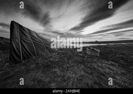 Upturned herring boats on the Island of  Lindisfarne (Holy Island on the Northumberland coast. England, UK, GB. Stock Photo