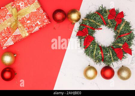 Christmas decoration with ornaments in red and gold color on marble background Stock Photo