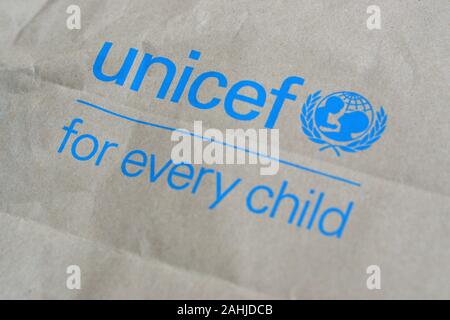 NY, USA - DECEMBER 29, 2019: Unicef blue logo on brown paper bag, United Nations Childrens Fund is agency responsible for providing humanitarian and d Stock Photo